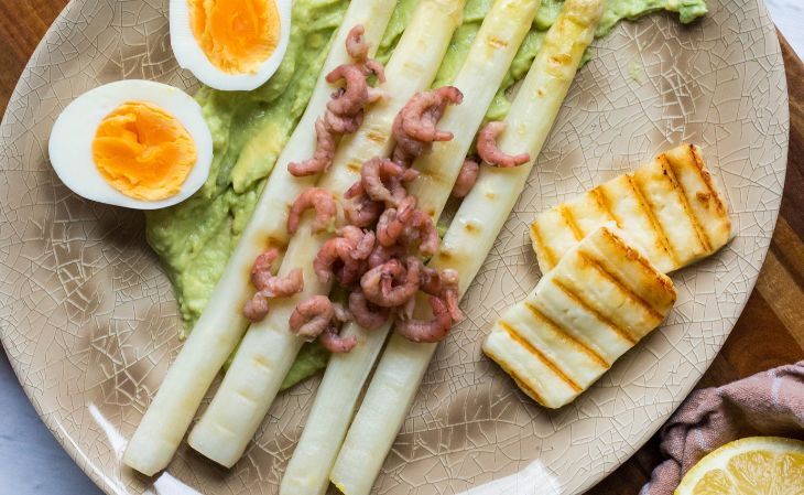 Grilled asparagus with halloumi, prawns, a hard-boiled egg and an avocado sauce